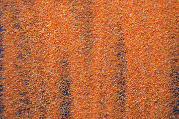 orange artificial sand on black table for background