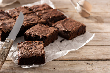Homemade pieces of brownies on wooden table	