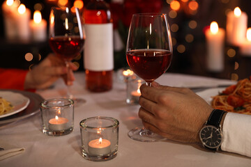 Couple having romantic dinner in restaurant, closeup