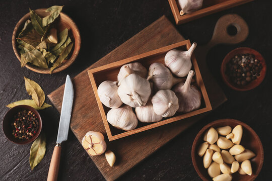 Box of fresh garlic on dark table