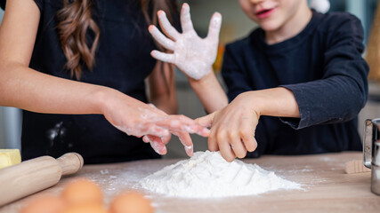 Siblings are cooking and fooling around on the kitchen