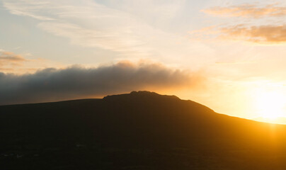 Sunset over mountain ridgeline.