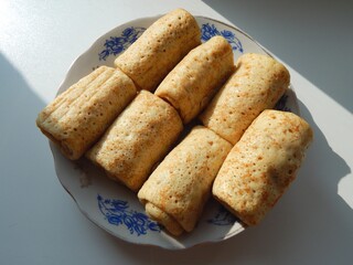 Delicious spring rolls on a plate. Stuffed pancakes for breakfast or dinner.
