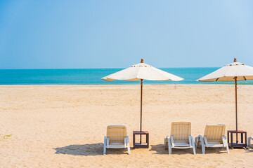 Umbrella and chair around outdoor swimming pool in hotel resort