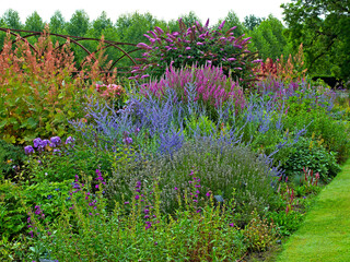 Colourful summer border at a French Country House garden with Perovskia atriplicifolia