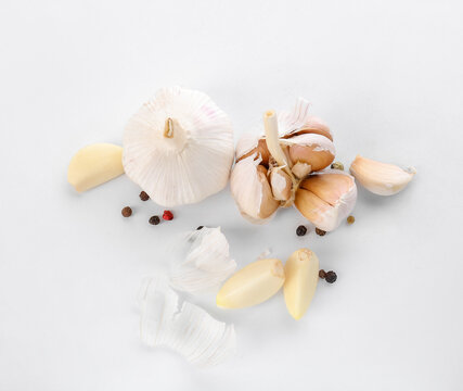 Fresh garlic with spices on white background