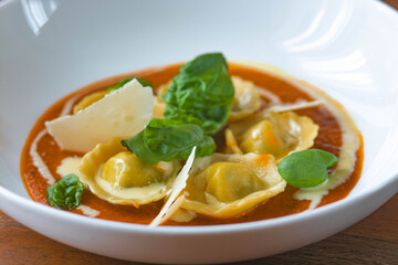 Handmade Tortelli with tomato sauce , basil and parmesan shavings. Revisited dish of Melanzane alla Parmigiana ( eggplant parmigiana)