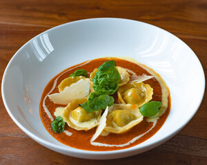 Handmade Tortelli with tomato sauce , basil and parmesan shavings. Revisited dish of Melanzane alla Parmigiana ( eggplant parmigiana)