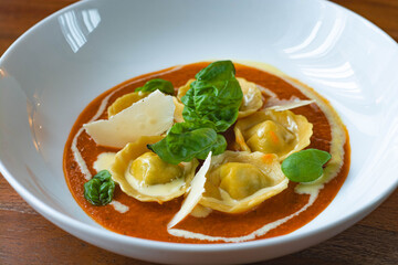 Handmade Tortelli with tomato sauce , basil and parmesan shavings. Revisited dish of Melanzane alla Parmigiana ( eggplant parmigiana)