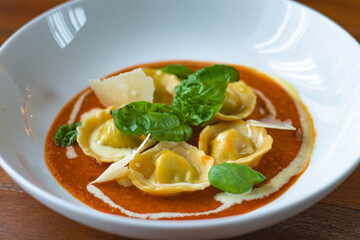 Handmade Tortelli with tomato sauce , basil and parmesan shavings. Revisited dish of Melanzane alla Parmigiana ( eggplant parmigiana)