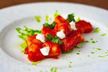 Gnocchi all'arrabbiata, with tomato sauce and parsely pesto. Vegan dish