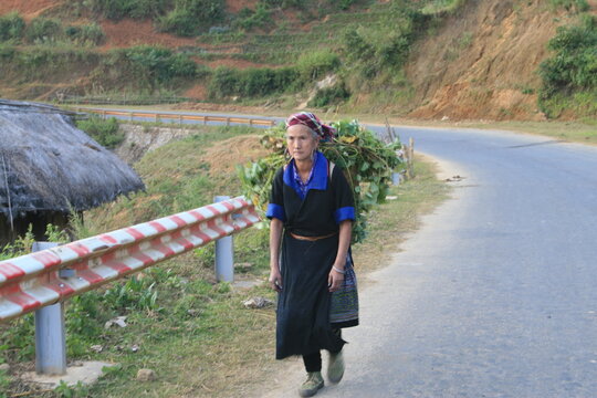 Mature Woman In Traditional Clothing Looking Away While Walking On Road