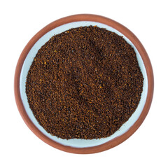 Top view of a small terracotta spice bowl filled with chili powder isolated on a white background.