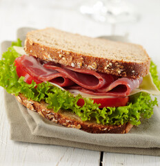 fresh deli sandwich with tomatoes, swiss chees, lettuce