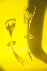 Empty glasses stand on a yellow background.Sunlight is refracted through the glass.Trending images.