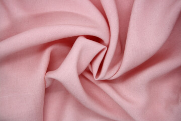 Fototapeta premium The background is made of synthetic fabric lying in waves.