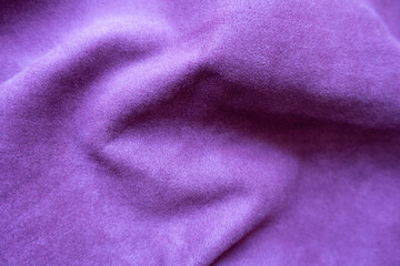 Fototapeta na wymiar Draped violet faux suede fabric from above