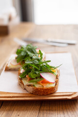 Healthy breakfast in the restaurant. Toast with arugula and salmon