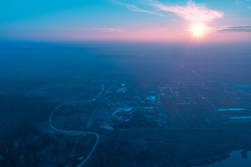 Rural landscape in the morning with the blue-pink sky. Aerial view of the countryside during sunrise