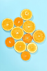 ripe slice orange fruit on blue background. top view