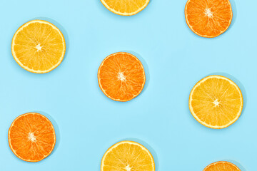 fruit pattern of fresh ripe slice orange on blue background. top view