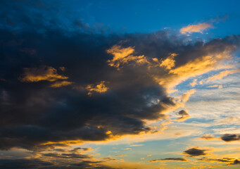 Naklejka na ściany i meble Beautiful sunset. Orange and black clouds in the sky