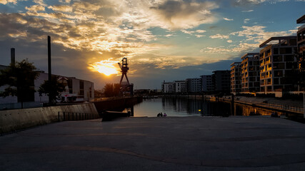 a sunset with clouds at the beginning of a river.