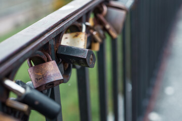 Many marriage love symbol padlocks chained on bridge