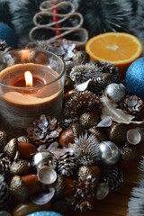 Close up Winter silver decoration with aroma candle, acorns, orange, new year's wreath, christmas concept