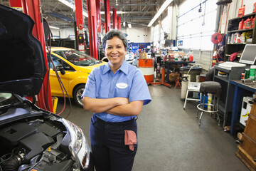 Portrait of female hispanic mechanic in auto repair shop
