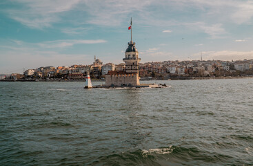 Beautiful panoramic sunset view of the Maiden's Tower in Üsküdar on the Asian side of Istanbul, Turkey with buildings and a bridge in the background