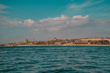 Panoramic sunset view of the Hagia Sophia Grand Mosque, Sultanahmet (Blue Mosque) Mosque and Topkapi Palace in Istanbul, Turkey seen from the Bosporus
