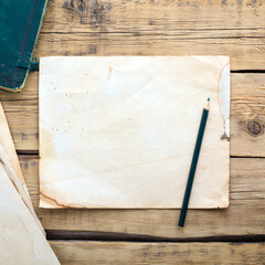 Old vintage note paper on a wooden table. Copy space