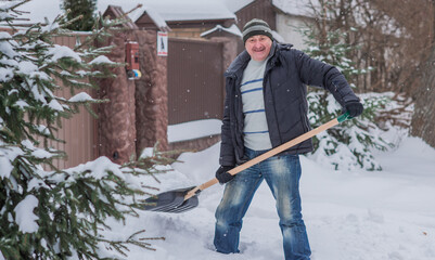 Snow collapse, man cleaning snow at winter weather with a shovel on a yard, winter trouble concept