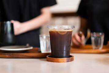 Iced coffee on wooden table at coffee shop
