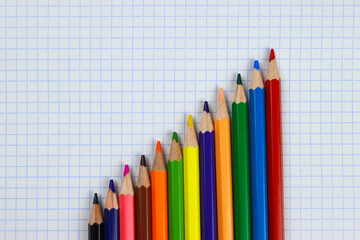 color pencils on notebook sheet close up