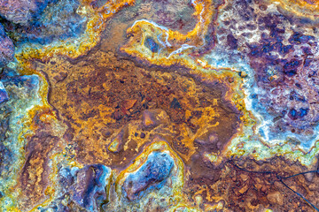 top down abstract view of a riverbed in an abandoned mining area with mineral and metal deposits in shallow water