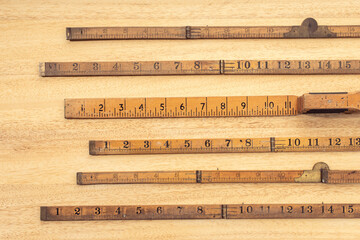 Group of Old wooden ruler on table. Measuring or accuracy concept