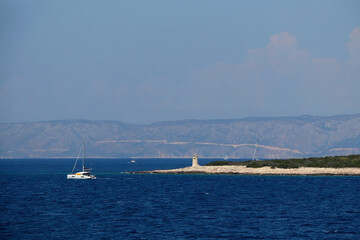 Obraz premium Sailing boat near island in Croatia. Beautiful Mediterranean landscape.