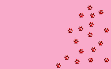Pink background with pet footprint. Dog or cat trace.