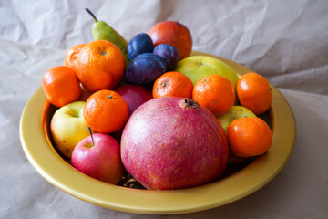 Big plate with lots of healthy fruits over paper background 