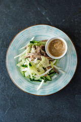 Delicious European lunch on a beautiful plate on a dark background. Nutritious Vegetable Food