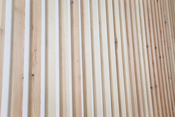 Photo of wooden slats on a white chalk wall