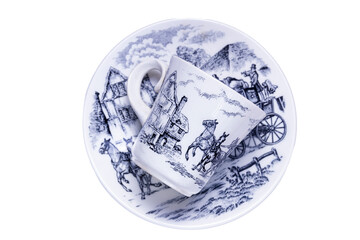 cup and dish off coffe with a baroque decoration over a table