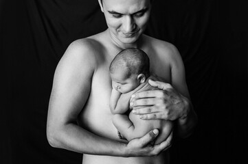 2. Father holding his newborn daughter at a newborn photoshoot