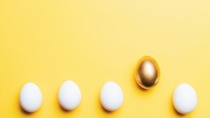 Easter border. Golden, white colour egg on pastel yellow background in Happy Easter decoration. Flat lay, top view.