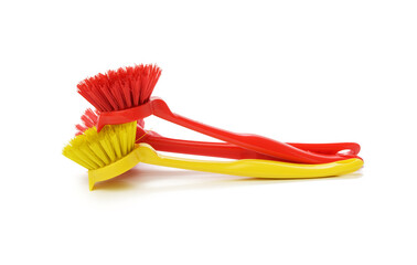 red and yellow plastic brushes with handle for cleaning isolated on white background