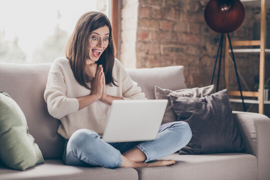 Photo Of Amazed Happy Woman Clap Hands Read News Laptop Sit Sofa Wear Jeans Pullover Inside Home Indoors House