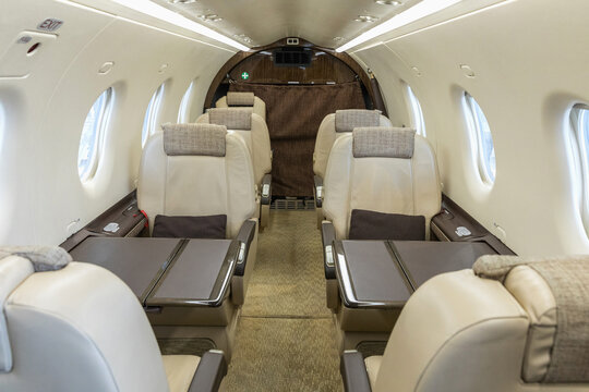 Luxury bright leather interior of a modern commercial airplane. Inside of a small business turboprop aircraft.