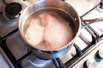 Boiling chicken breast in a saucepan